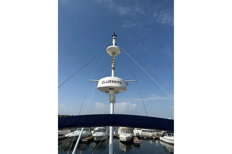 Slide: The Image of 1996 Grand Banks 42 Classic yacht docked at marina under clear blue sky. - 9