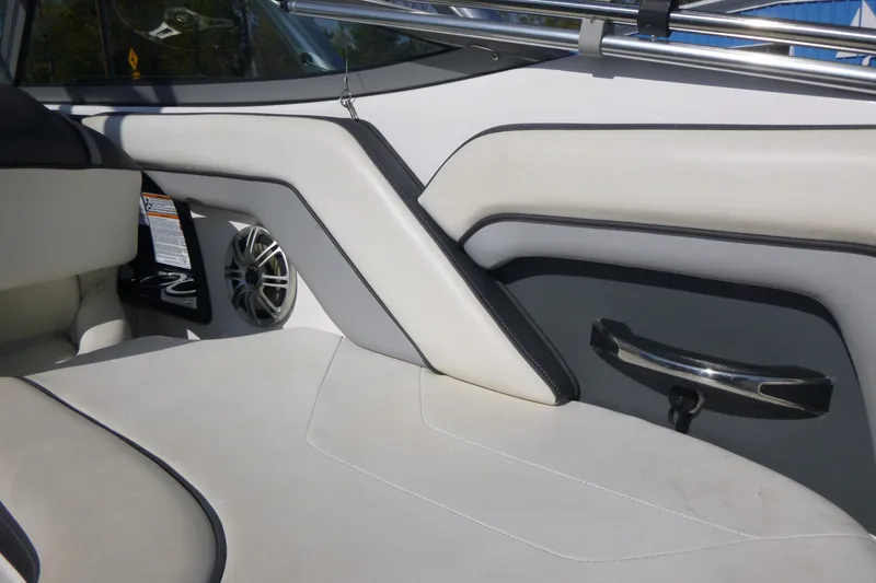Slide: The Image of 2015 Yamaha Boats SX192 interior with sleek white seating and modern speaker design. - 10