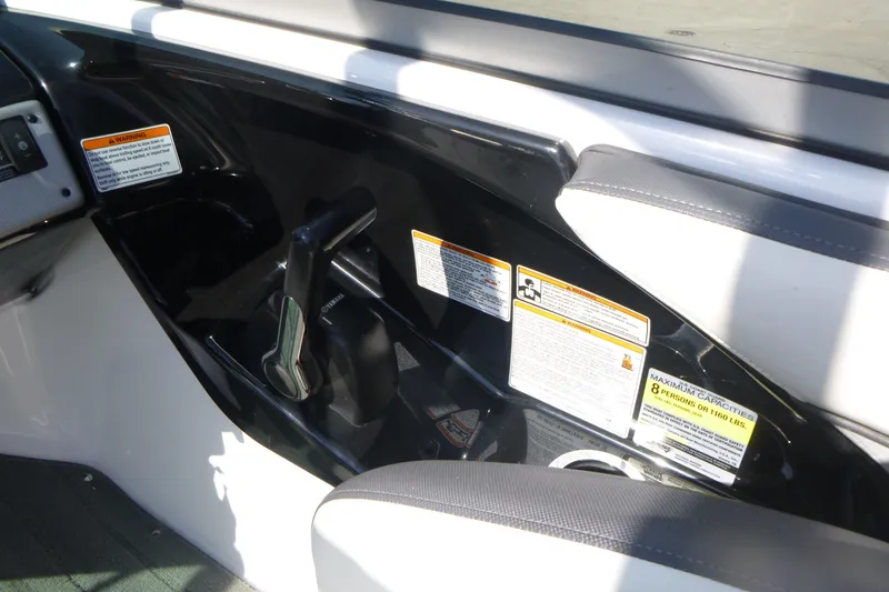 Slide: The Image of 2015 Yamaha Boats SX192 interior with control lever and safety warnings. - 11