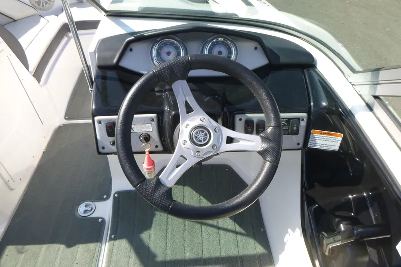Slide: The Image of Steering wheel and dashboard of 2015 Yamaha Boats SX192, featuring control panel and gauges. - 12