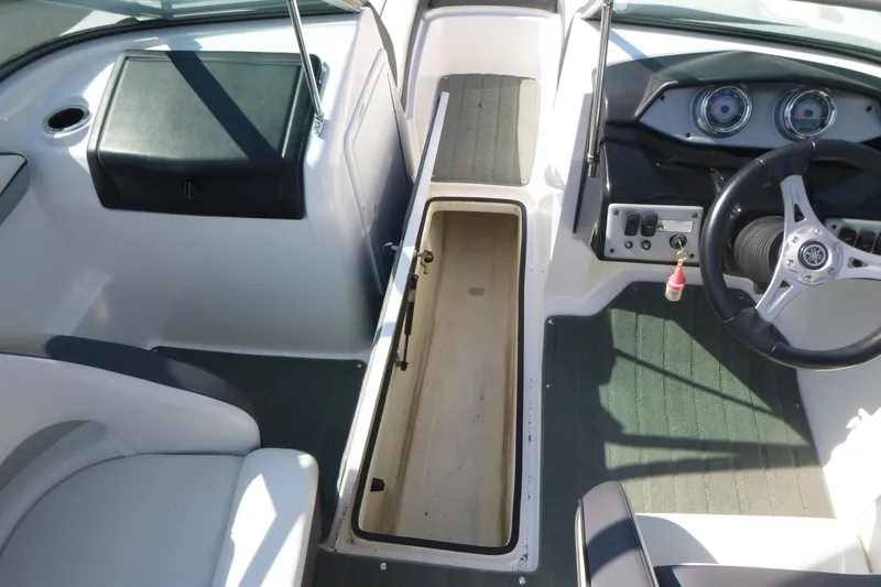Slide: The Image of 2015 Yamaha Boats SX192 interior with steering wheel and storage compartment. - 17