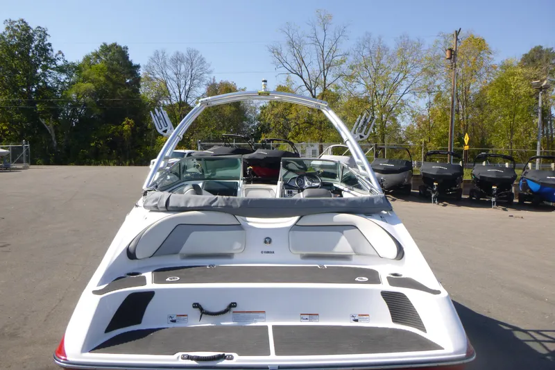 Slide: The Image of 2015 Yamaha Boats SX192, rear view, parked outdoors with trees in the background. - 3