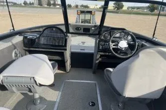 Slide: The Image of 2018 Starweld Fusion Pro 18 DC boat on trailer, parked outdoors. - 2