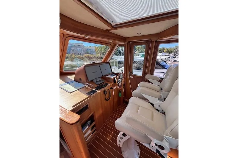 Slide: The Image of Interior of 2012 Sabre 42 Salon Express yacht with helm and seating area. - 12
