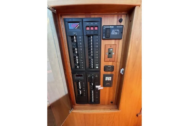 Slide: The Image of Electrical panel on 2012 Sabre 42 Salon Express yacht, featuring switches and controls. - 13