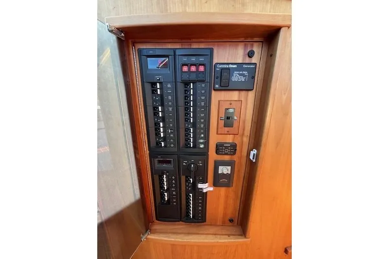 Slide: The Image of Electrical panel inside 2012 Sabre 42 Salon Express yacht, featuring circuit breakers and controls. - 14