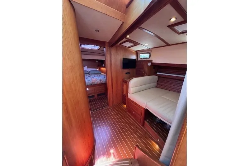 Slide: The Image of Interior of 2012 Sabre 42 Salon Express yacht, featuring cozy seating and wood finishes. - 16