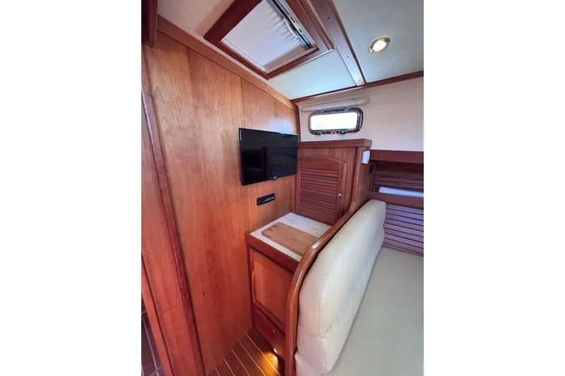 Slide: The Image of Interior of 2012 Sabre 42 Salon Express with wood paneling and mounted TV. - 18