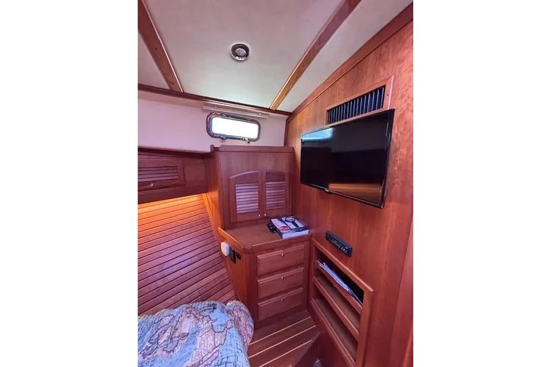 Slide: The Image of Interior of 2012 Sabre 42 Salon Express with wood paneling and mounted TV. - 21