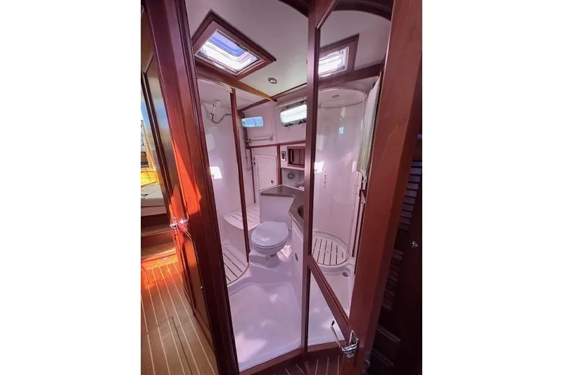 Slide: The Image of 2012 Sabre 42 Salon Express bathroom with shower, toilet, and wooden accents. - 23
