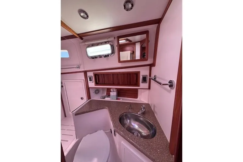 Slide: The Image of 2012 Sabre 42 Salon Express bathroom with sink, mirror, and porthole window. - 25