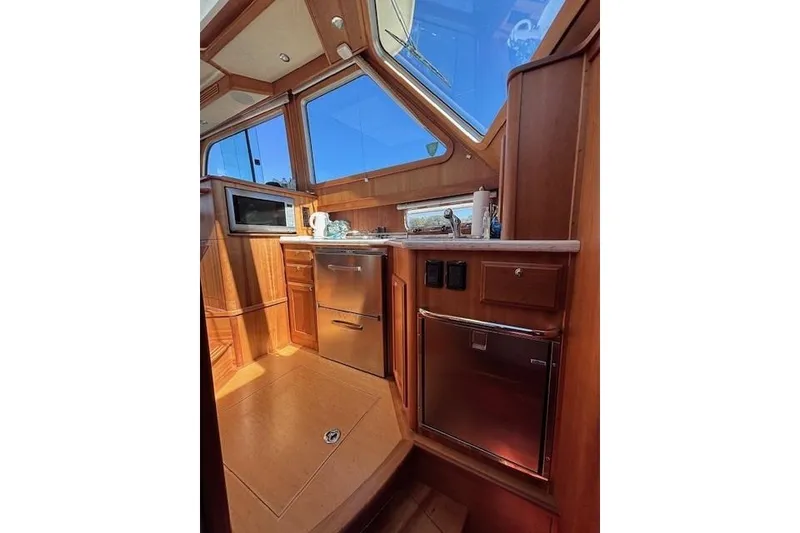 Slide: The Image of Interior of 2012 Sabre 42 Salon Express yacht with wooden cabinetry and modern appliances. - 26