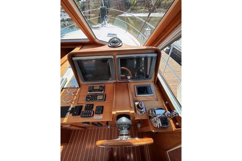 Slide: The Image of 2012 Sabre 42 Salon Express helm with dual screens and wooden dashboard. - 29