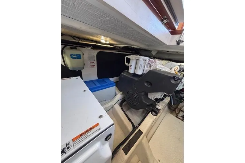 Slide: The Image of Engine room of 2012 Sabre 42 Salon Express, showcasing mechanical components and storage. - 36