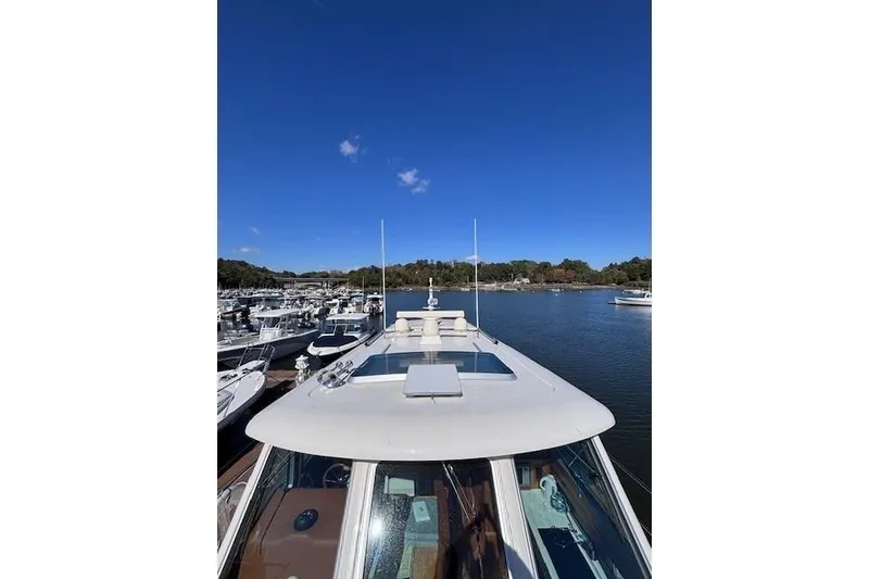Slide: The Image of 2012 Sabre 42 Salon Express yacht docked in a marina under clear blue skies. - 42