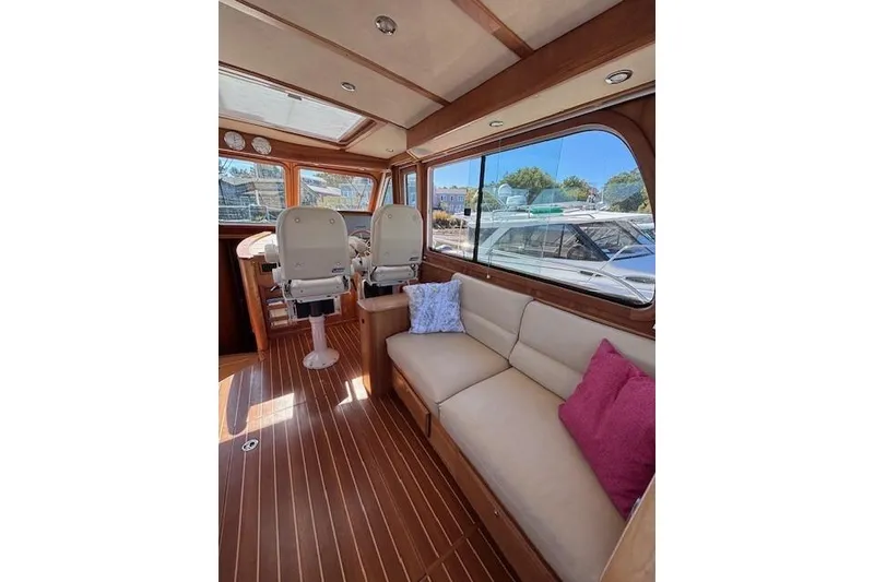 Slide: The Image of Interior of 2012 Sabre 42 Salon Express yacht with plush seating and helm chairs. - 9