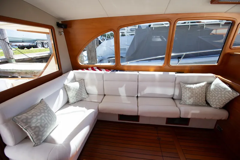 Slide: The Image of Luxurious interior of 2017 Palm Beach PB42 yacht with white seating and wooden accents. - 16
