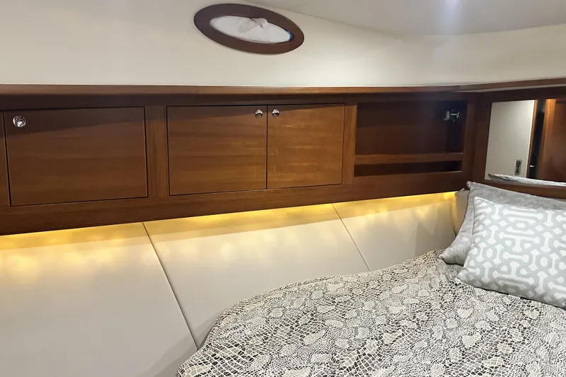 Slide: The Image of Luxurious 2017 Palm Beach PB42 yacht interior with elegant wood cabinetry and cozy bedding. - 23