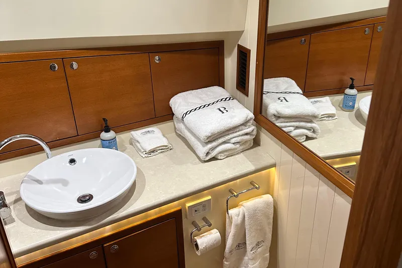 Slide: The Image of Luxurious bathroom in 2017 Palm Beach PB42 yacht with elegant wood cabinetry and plush towels. - 26