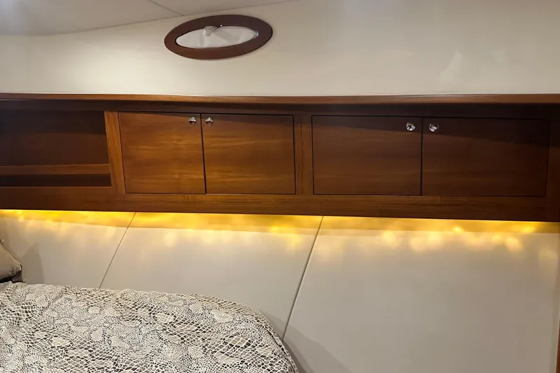 Slide: The Image of Luxurious 2017 Palm Beach PB42 yacht interior with wooden cabinets and ambient lighting. - 28
