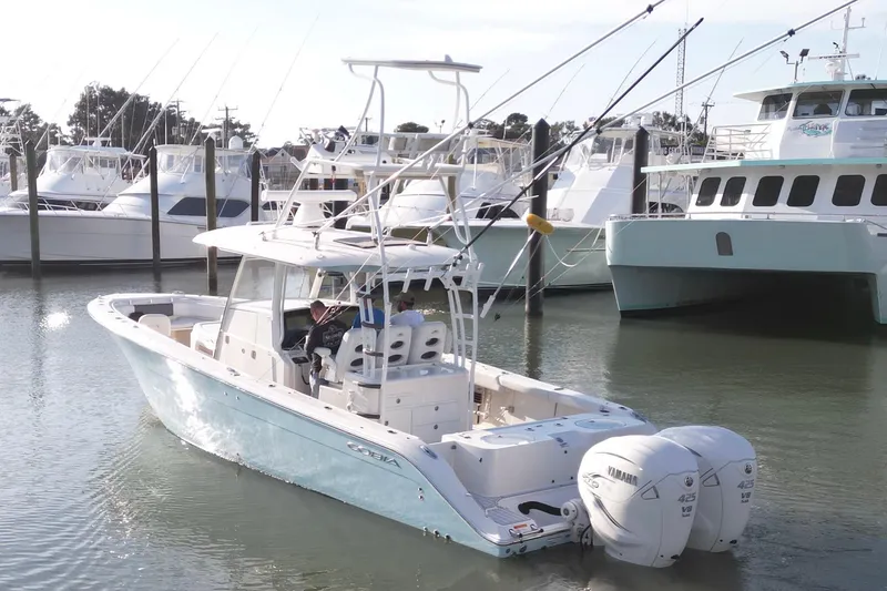 Slide: The Image of 2020 Cobia 350 Center Console boat docked with twin Yamaha engines. - 12
