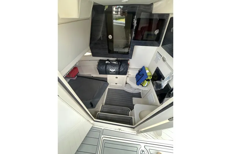 Slide: The Image of 2020 Cobia 350 Center Console cabin interior with seating, storage, and modern amenities. - 14