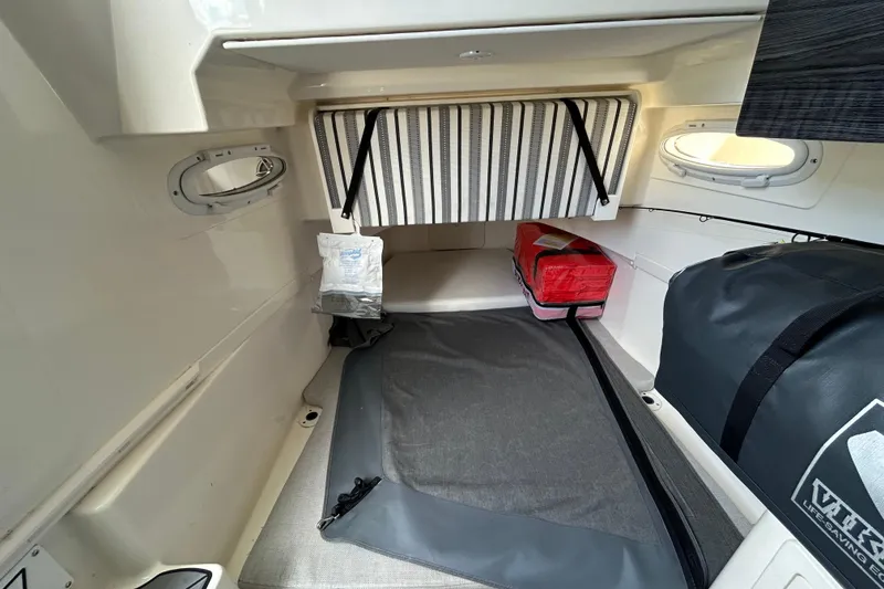 Slide: The Image of 2020 Cobia 350 Center Console cabin interior with storage bags and portholes. - 15