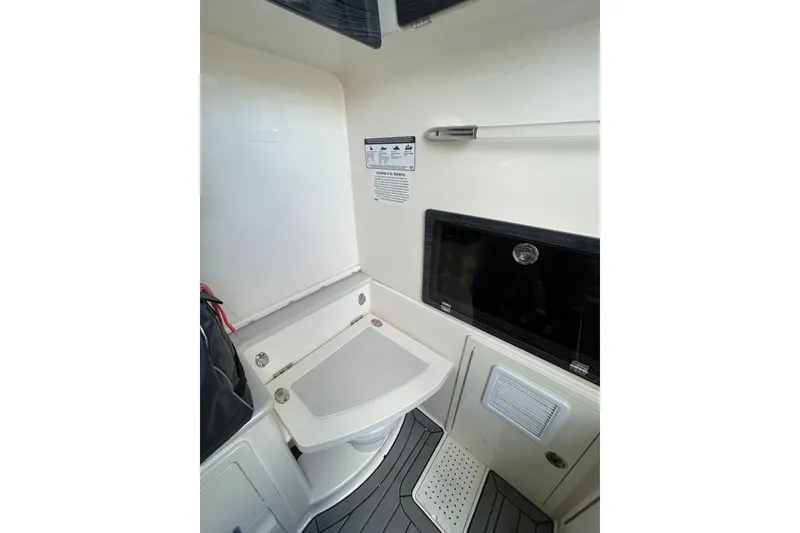 Slide: The Image of 2020 Cobia 350 Center Console interior cabin with seating and storage. - 16