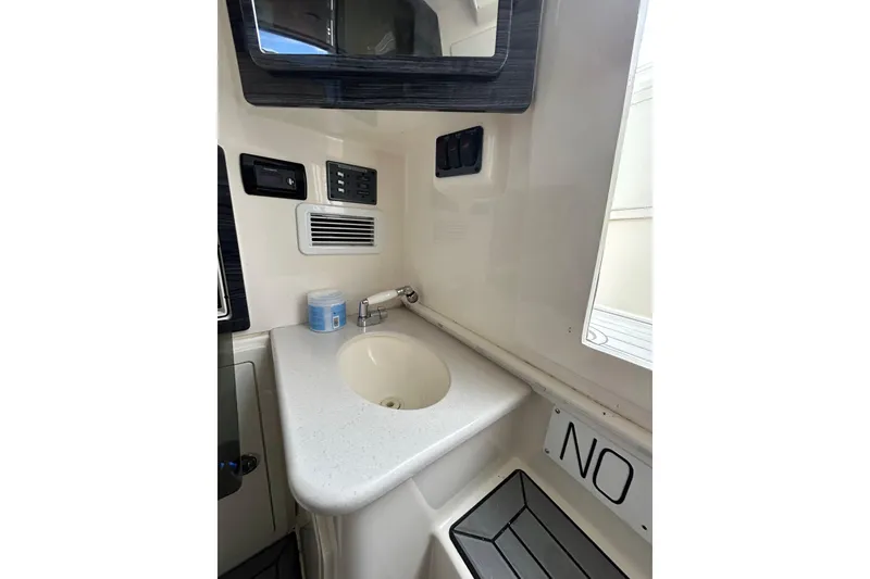 Slide: The Image of 2020 Cobia 350 Center Console boat interior with sink and control panel. - 18