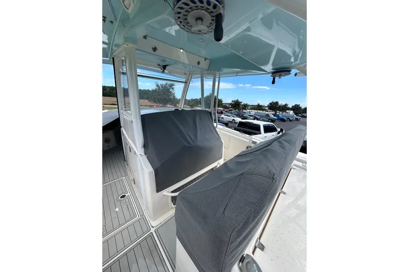 Slide: The Image of 2020 Cobia 350 Center Console boat interior with covered seating and helm. - 20