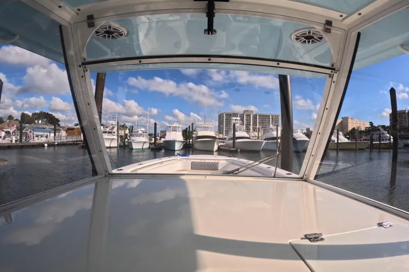 Slide: The Image of 2020 Cobia 350 Center Console boat docked in a marina under a clear blue sky. - 3