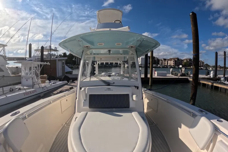 Slide: The Image of 2020 Cobia 350 Center Console boat docked at marina under blue sky. - 6