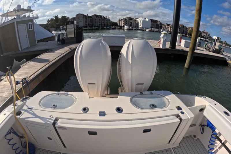 Slide: The Image of 2020 Cobia 350 Center Console at dock with twin engines and live wells. - 9