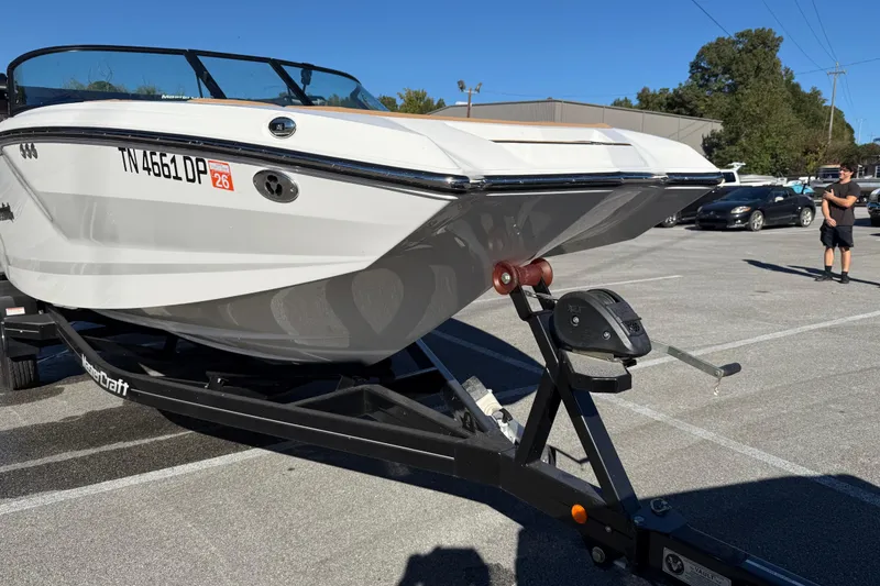 Slide: The Image of 2022 MasterCraft NXT24 boat on trailer in parking lot, sunny day. - 17