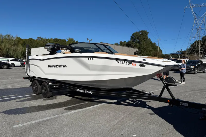 Slide: The Image of 2022 MasterCraft NXT24 boat on trailer in parking lot. - 18