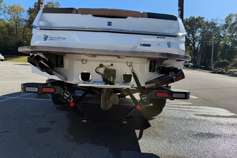 Slide: The Image of Rear view of 2022 MasterCraft NXT24 boat on trailer in sunny parking lot. - 22