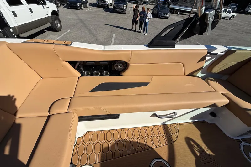 Slide: The Image of 2022 MasterCraft NXT24 boat interior with tan seating and modern design. - 25
