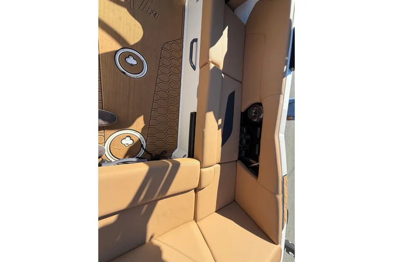 Slide: The Image of 2022 MasterCraft NXT24 interior with tan seating and hexagonal floor design. - 30