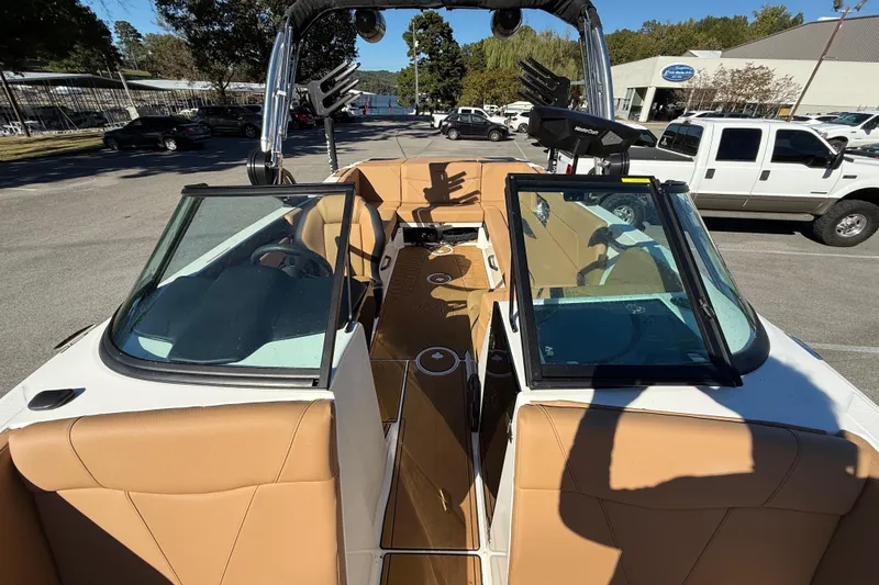 Slide: The Image of 2022 MasterCraft NXT24 boat interior with tan seating and open windshield. - 31