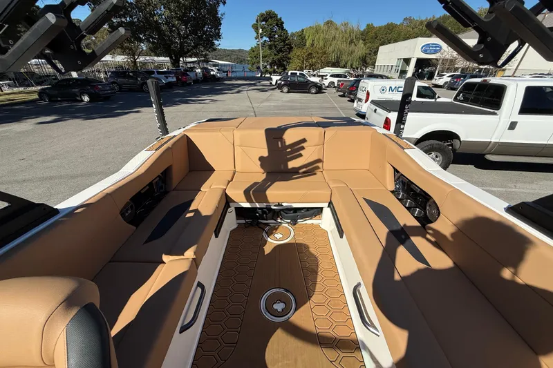 Slide: The Image of 2022 MasterCraft NXT24 boat interior with tan seating and hexagonal floor design. - 32