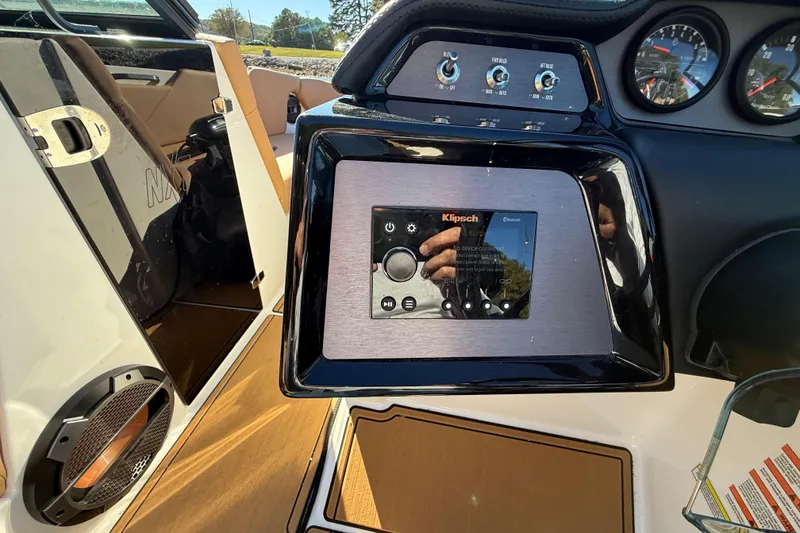 Slide: The Image of 2022 MasterCraft NXT24 dashboard with Klipsch audio system and control panel. - 35