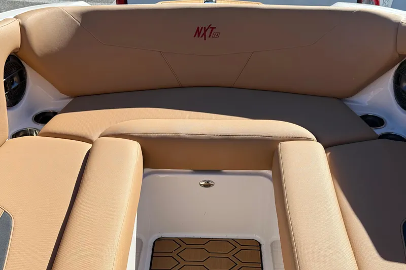 Slide: The Image of 2022 MasterCraft NXT24 boat interior with tan seating and stylish design. - 36