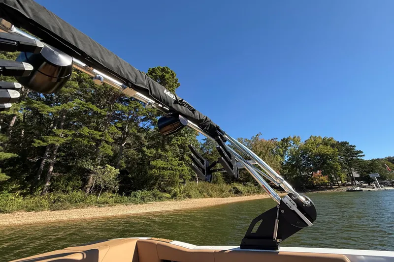 Slide: The Image of 2022 MasterCraft NXT24 boat with wakeboard tower on a sunny lake. - 38