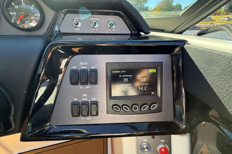 Slide: The Image of Control panel of a 2022 MasterCraft NXT24 boat with digital display and switches. - 41