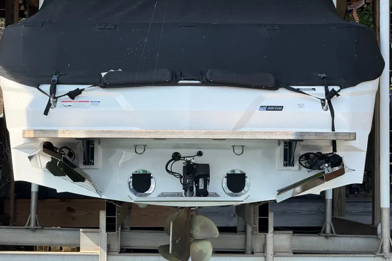Slide: The Image of 2022 MasterCraft NXT24 boat docked with cover on a serene lake. - 5