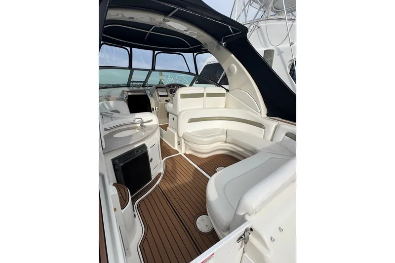 Slide: The Image of 2007 Sea Ray 320 Sundancer interior with white seating and wood flooring. - 10