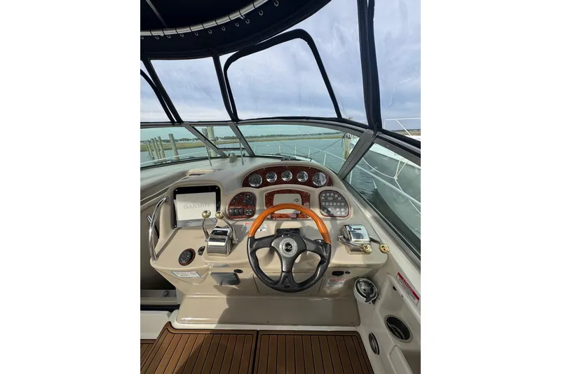 Slide: The Image of Cockpit view of 2007 Sea Ray 320 Sundancer with steering wheel and navigation controls. - 17