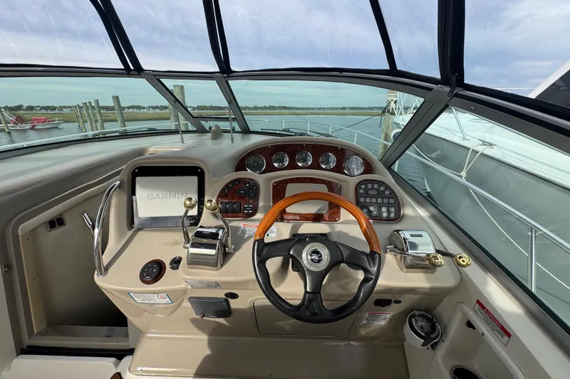 Slide: The Image of Cockpit view of 2007 Sea Ray 320 Sundancer with steering wheel and navigation controls. - 18