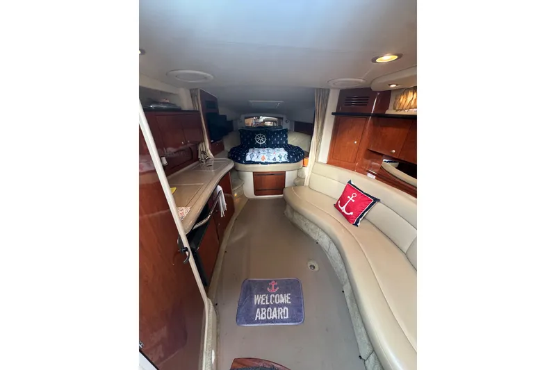 Slide: The Image of Interior of 2007 Sea Ray 320 Sundancer with cozy seating and nautical decor. - 19