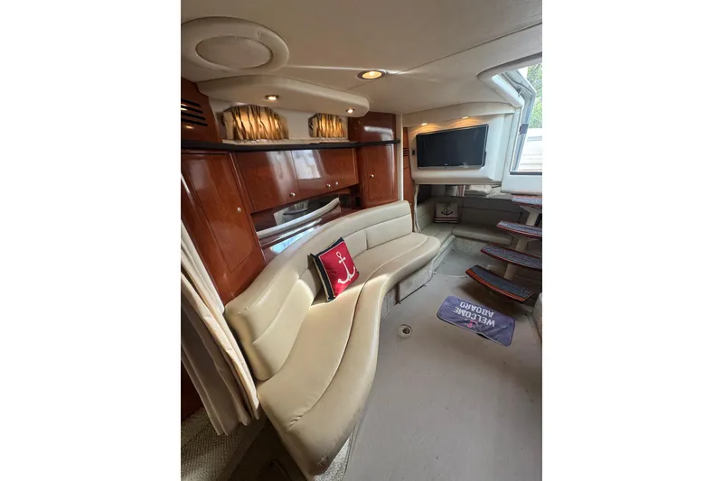 Slide: The Image of Luxurious interior of 2007 Sea Ray 320 Sundancer yacht with plush seating and TV. - 20